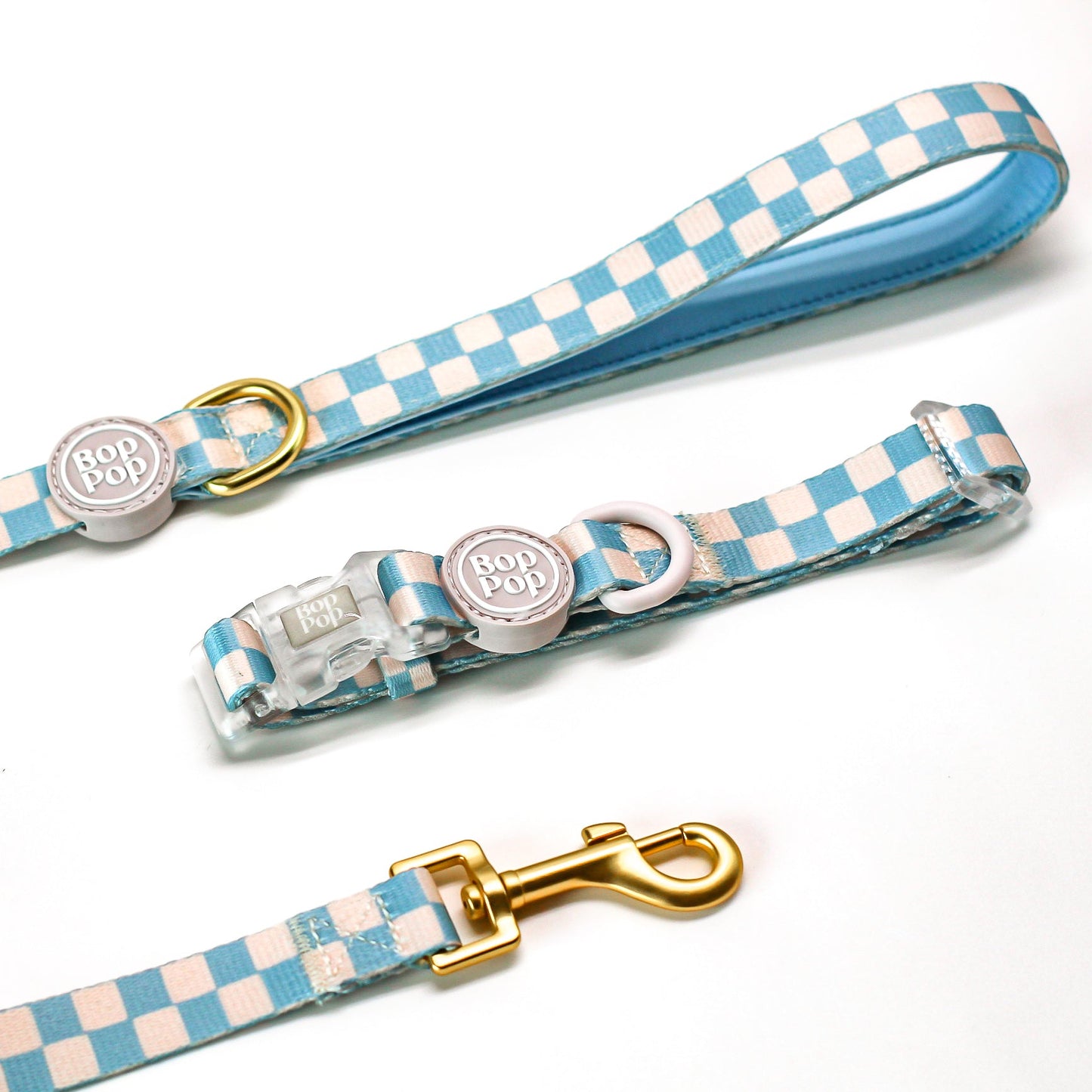Dog collar and leash set with blue and white checkered pattern on a white background
