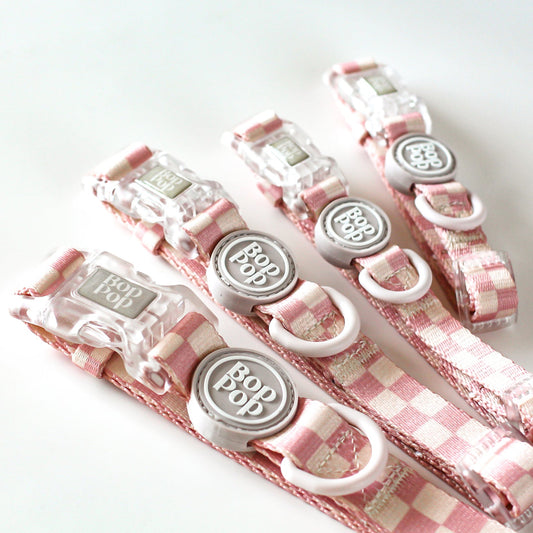 Set of pink checkered dog collars with tan cream off white linen colored hardware and plastic buckles. Trendy girl dog style for stylish dog moms