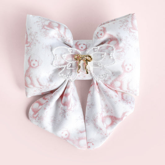 Large decorative bow with floral pattern on a pink background