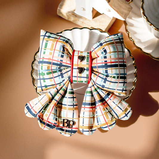 Plaid bow with gold plated heart metal buttons with decorative items. Holiday dog bows for premium handmade dog goods. Bop Pop Pets scalloped bows. Red satin piping trim for festive style