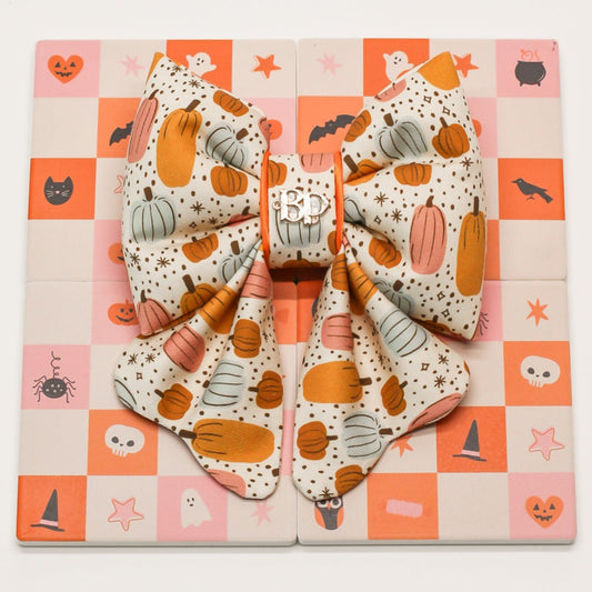 Pumpkin magic bow tie for pets dogs and cats. Halloween-themed or Fall autumn theme on a checkered background