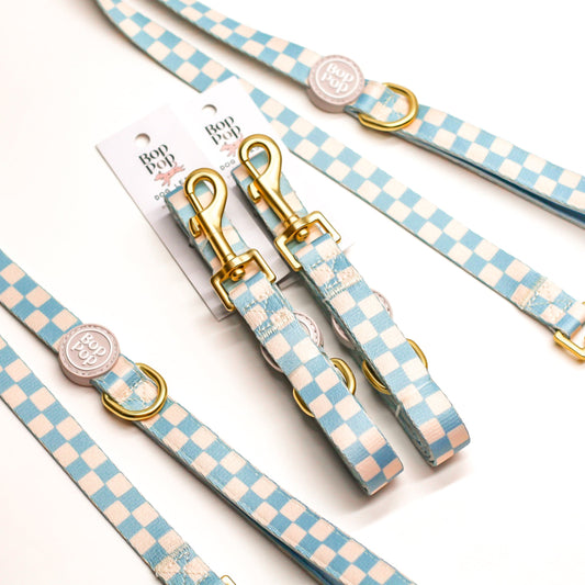 Dog leash and collar set with blue and white checkered pattern with gold clasp harware