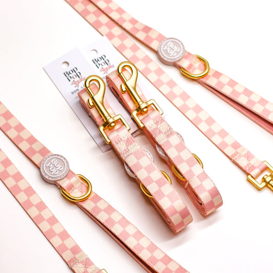 Pink checkered dog leash and collar set with gold clasp hardware