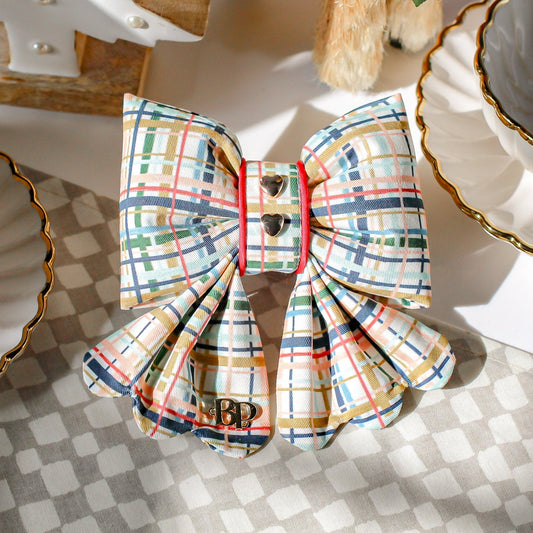 Plaid bow with gold plated heart metal buttons with decorative items. Holiday dog bows for premium handmade dog goods. Bop Pop Pets scalloped bows. Red satin piping trim for festive style