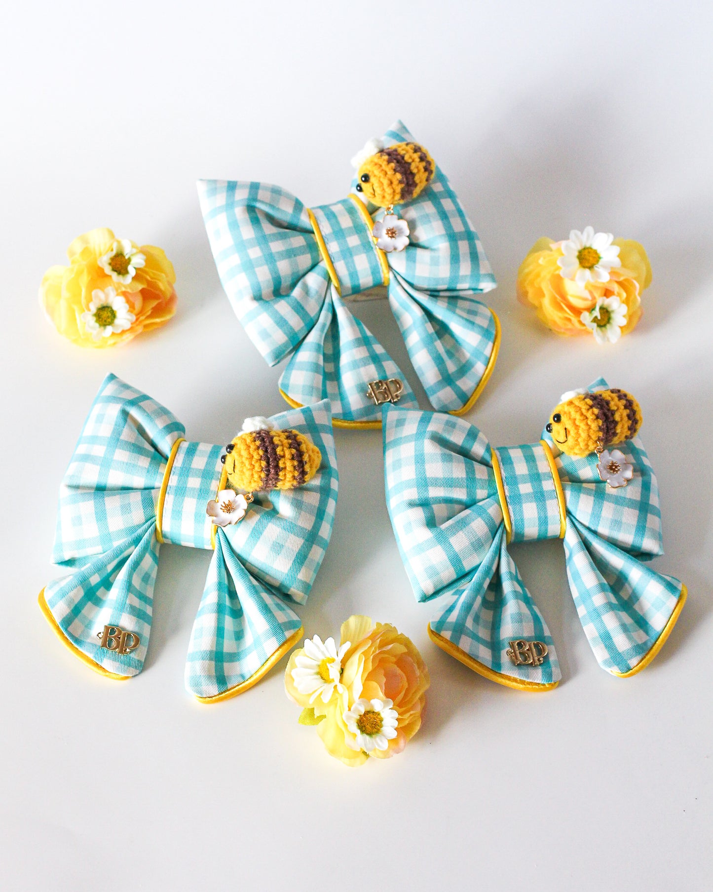 Colorful blue gingham sailor bow with crochet bee and metal flower daisy charm. Sailor bow for dog collars. Fashion dogs and dog mom style for beach summer style vibes. Hand made design with neon super bright summer florals with oranges. Cutest dog accessory for dogs and cats.