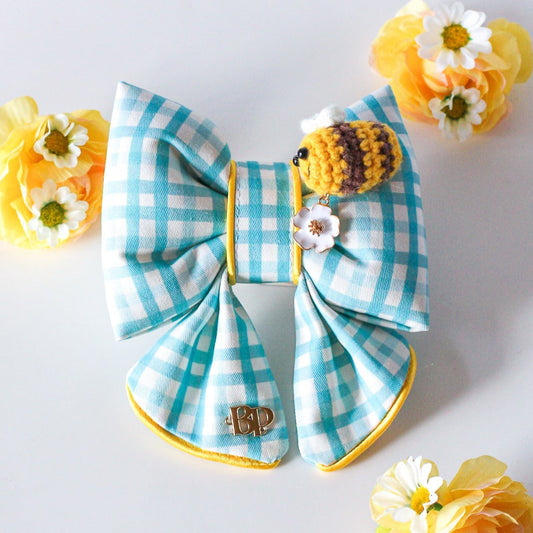 Colorful blue gingham sailor bow with crochet bee and metal flower daisy charm. Sailor bow for dog collars. Fashion dogs and dog mom style for beach summer style vibes. Hand made design with neon super bright summer florals with oranges. Cutest dog accessory for dogs and cats.