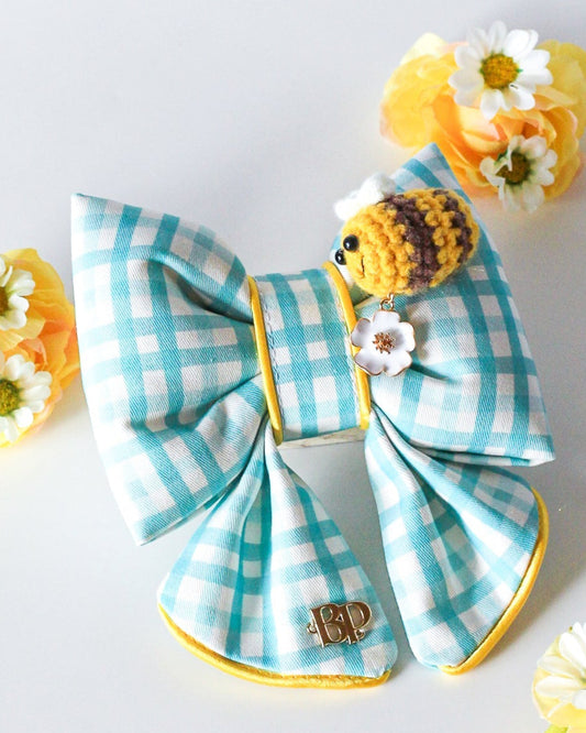 Colorful blue gingham sailor bow with crochet bee and metal flower daisy charm. Sailor bow for dog collars. Fashion dogs and dog mom style for beach summer style vibes. Hand made design with neon super bright summer florals with oranges. Cutest dog accessory for dogs and cats.