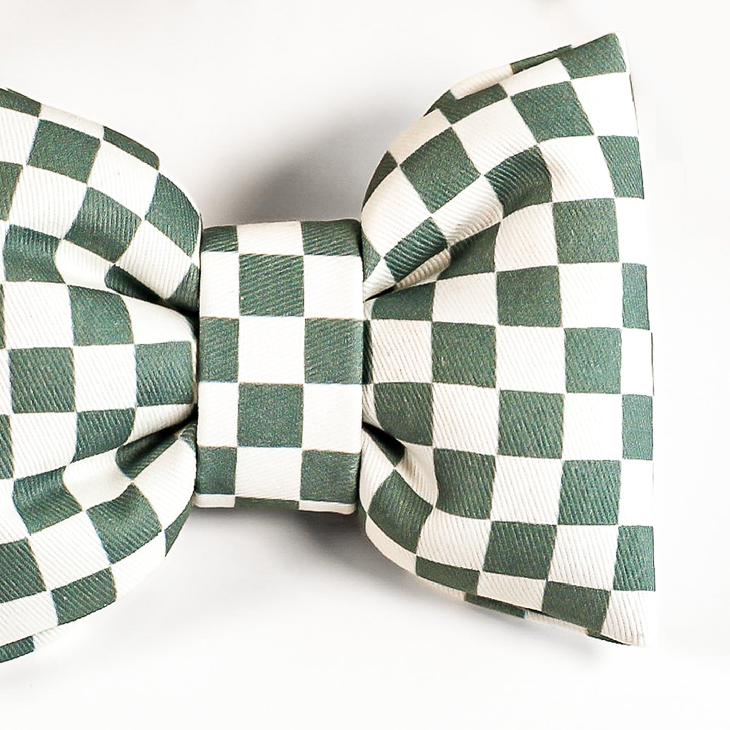 Green and white checkered bow tie on a white background