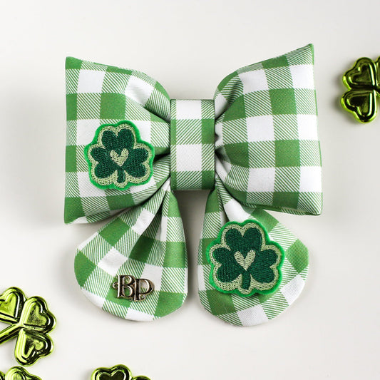 Green and white checkered bow with shamrock designs on a white background