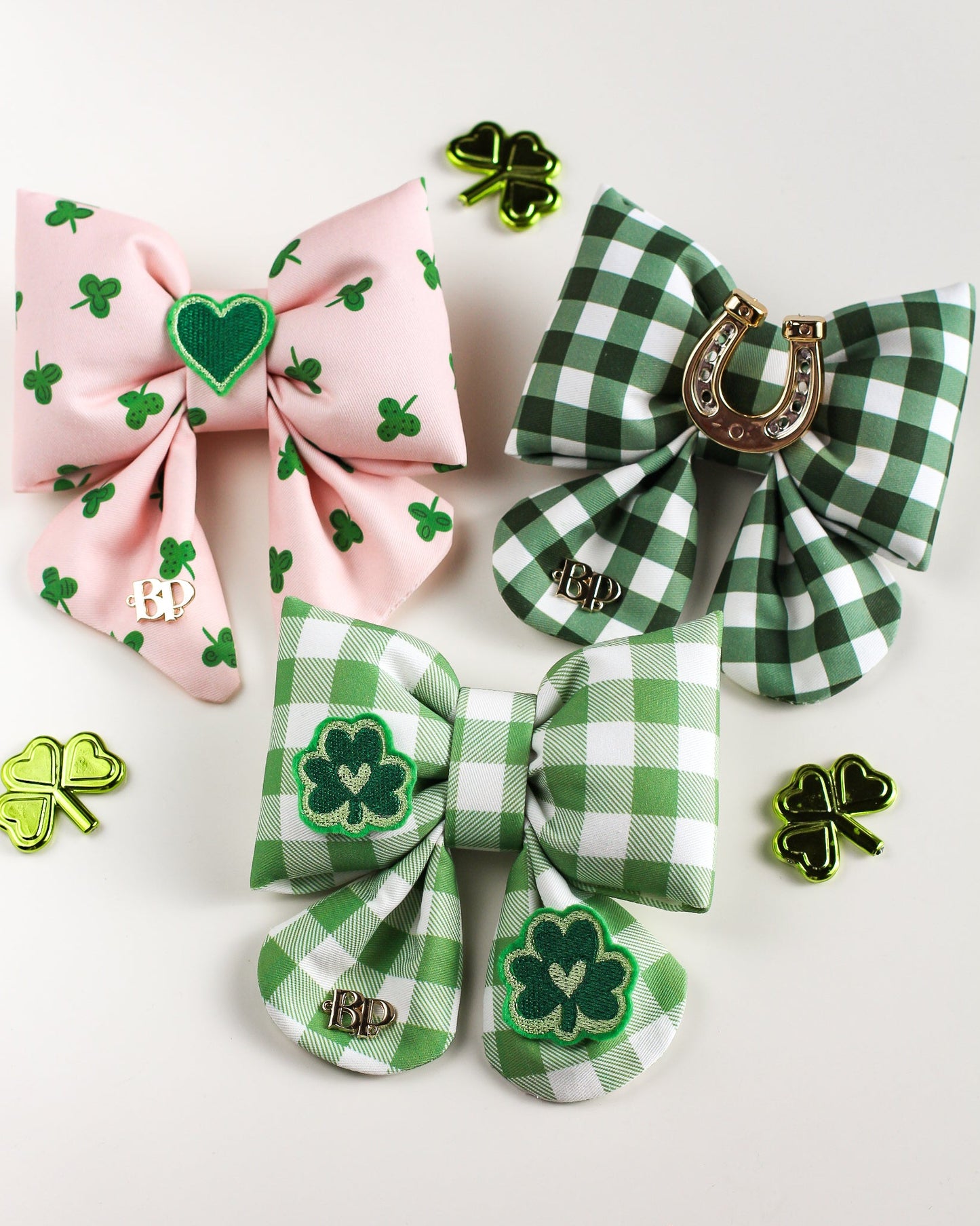 Three decorative dog sailor bows with shamrock designs plaid, pink cotton on white background