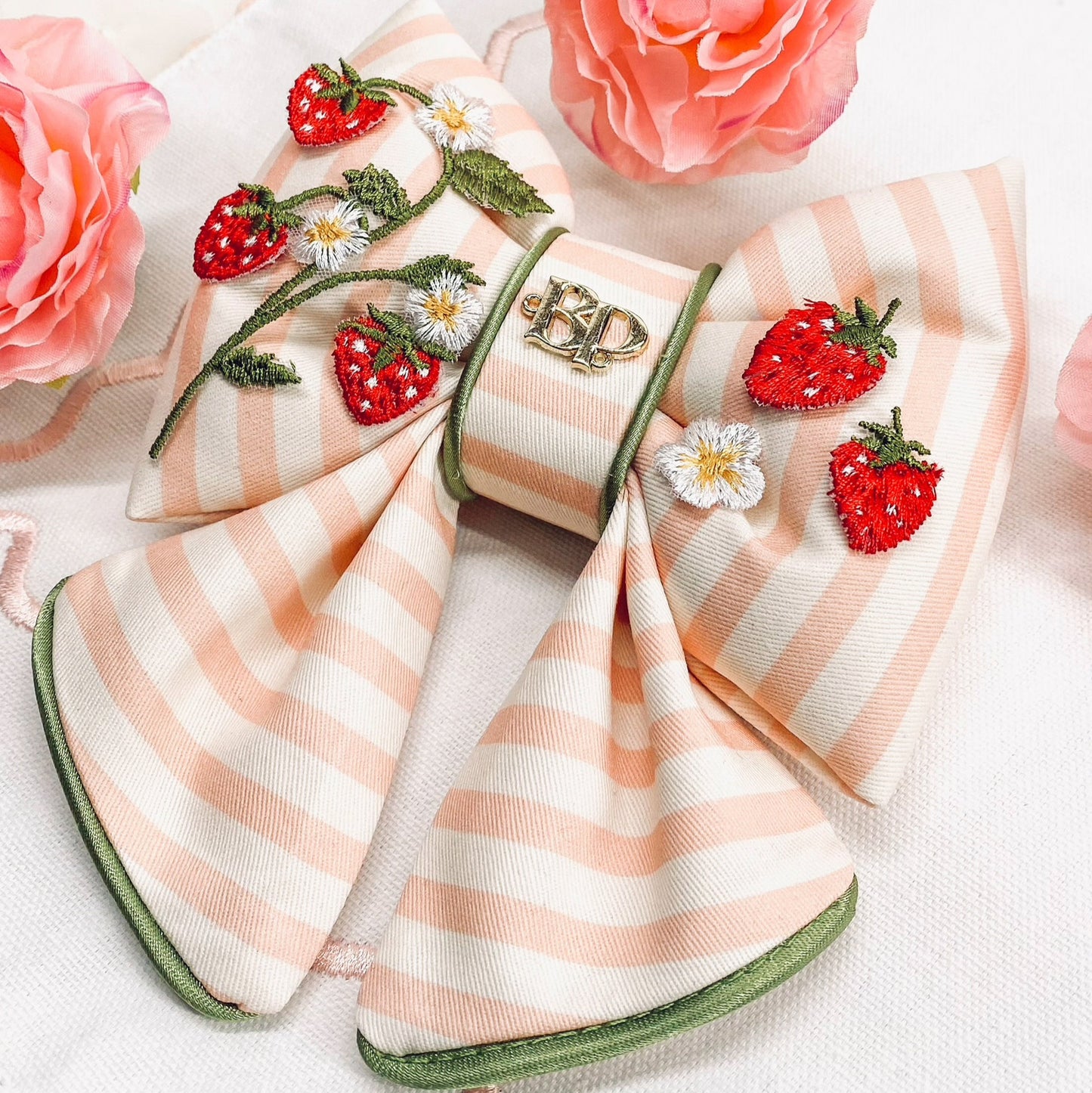 strawberry shortcake dog collar bow tie and sailor bow for pets dog or cat. Strawberry embroidery patch with organic cotton pink striped fabric. Dog mom girl dog style. Green olive satin trim on elevated pet bows and elevated pet accessories bop pop pets puffy bows