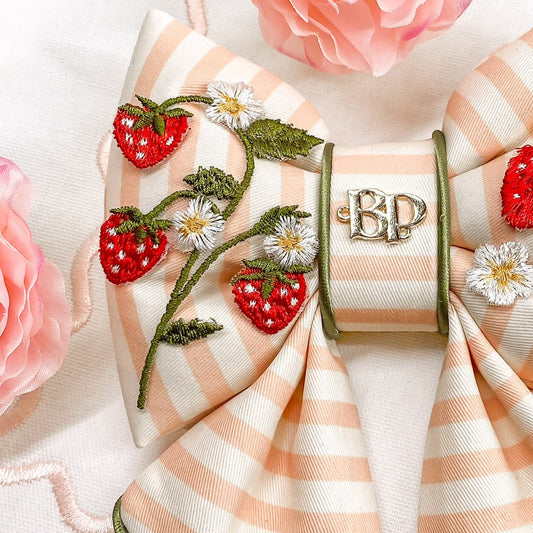 strawberry shortcake dog collar bow tie and sailor bow for pets dog or cat. Strawberry embroidery patch with organic cotton pink striped fabric. Dog mom girl dog style. Green olive satin trim on elevated pet bows and elevated pet accessories bop pop pets puffy bows