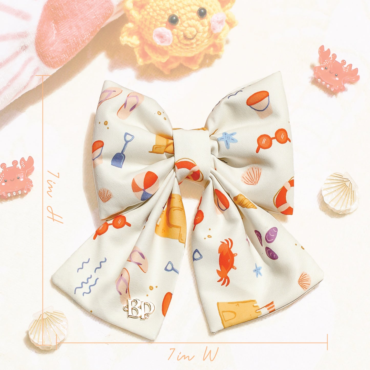Colorful dog bow with ocean-themed design on a textured surface. Bop Pop Pets for trendy dogs and cats. Size dimensions 7in x 7in
