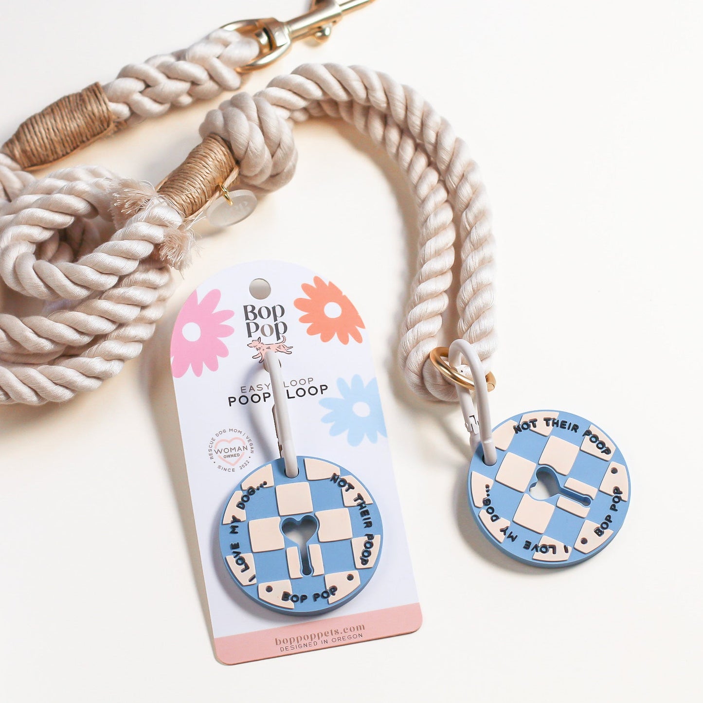 Dog leash with checkered poop loop with carabiner design on a white background