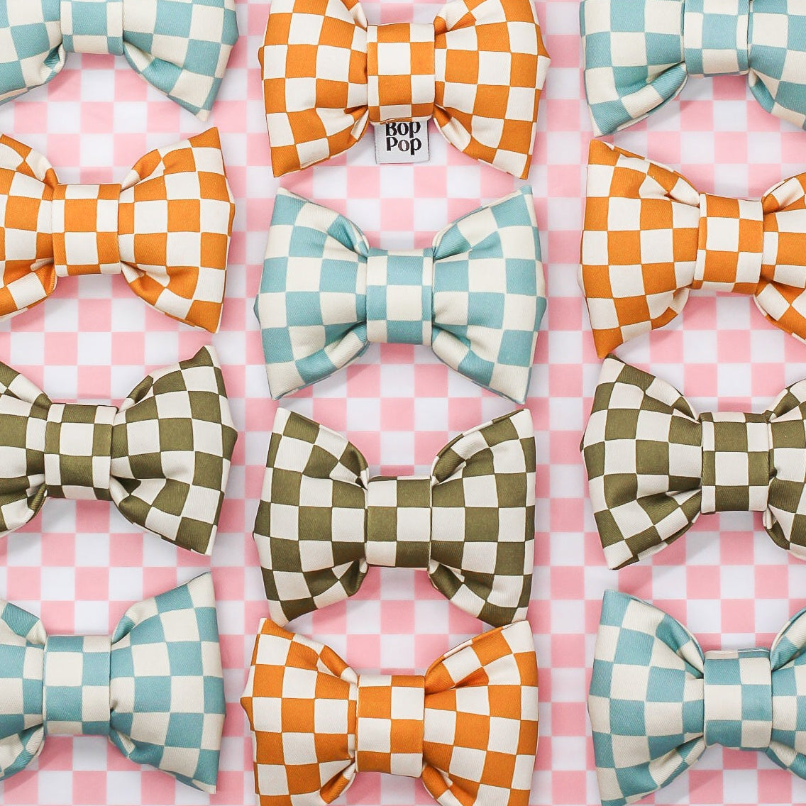 Set of colorful checkered bows on a pink and white checkered background