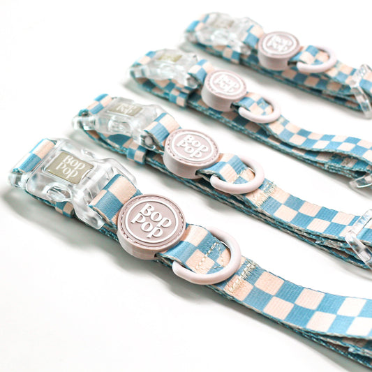 Set of dog collars with checkered blue pattern and bop pop logo rubber tag. Sizes xs, small, medium and large pet accessories