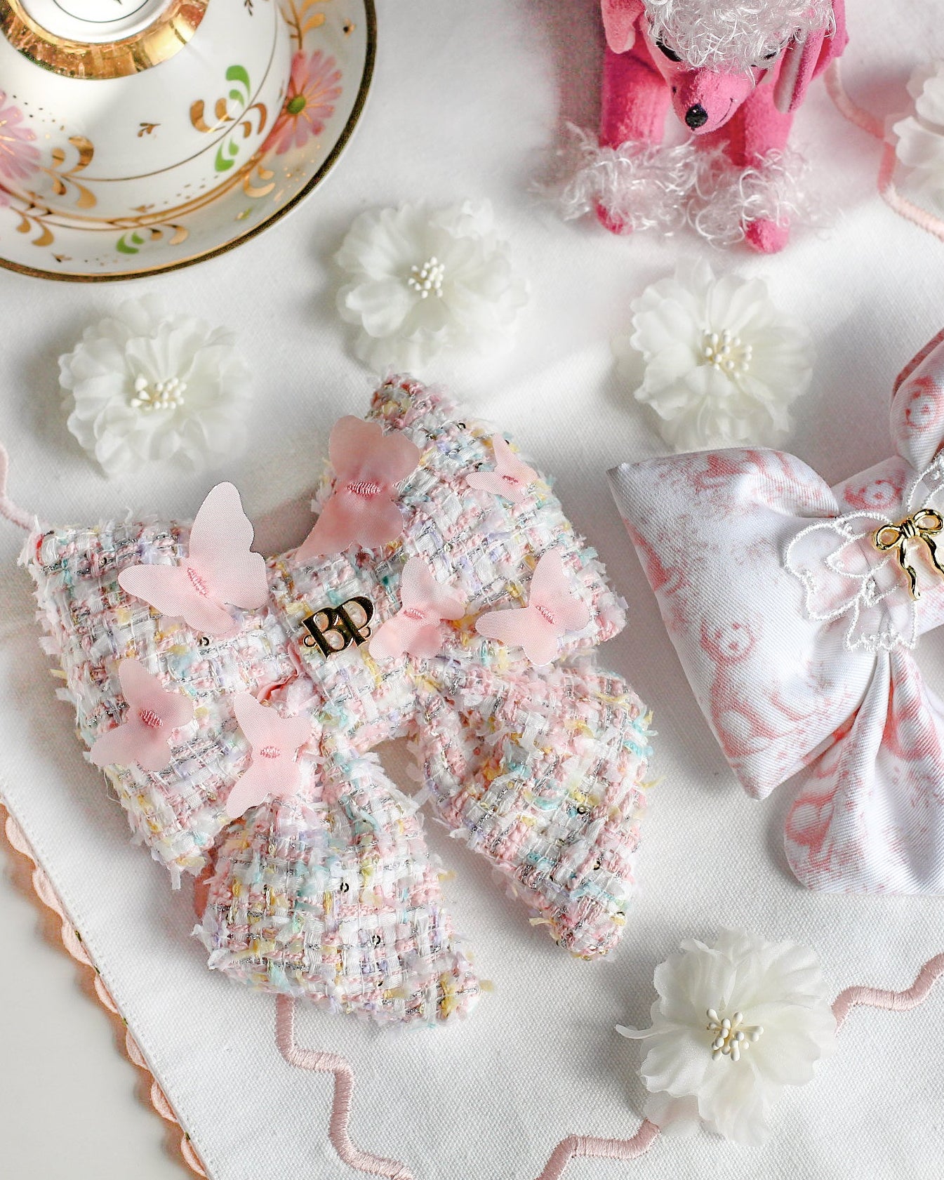 Decorative bows with floral details on a white surface with a decorative mat.