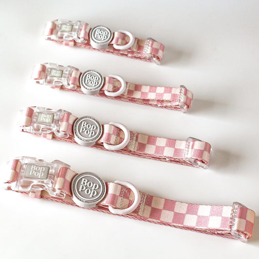Set of pink checkered dog collars with tan cream off white linen colored hardware and plastic buckles. Trendy girl dog style for stylish dog moms
