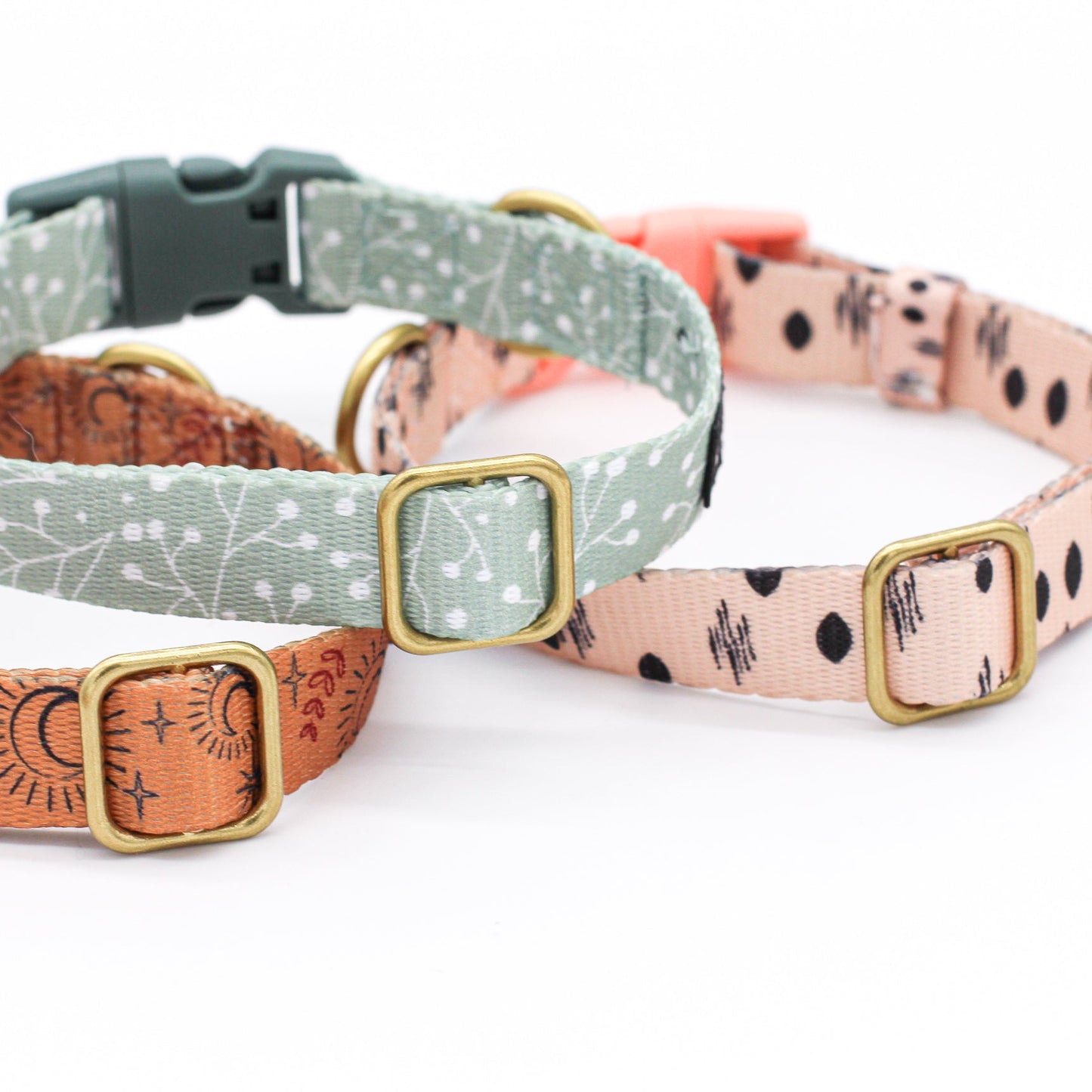 Three dog collars with different patterns on a white background