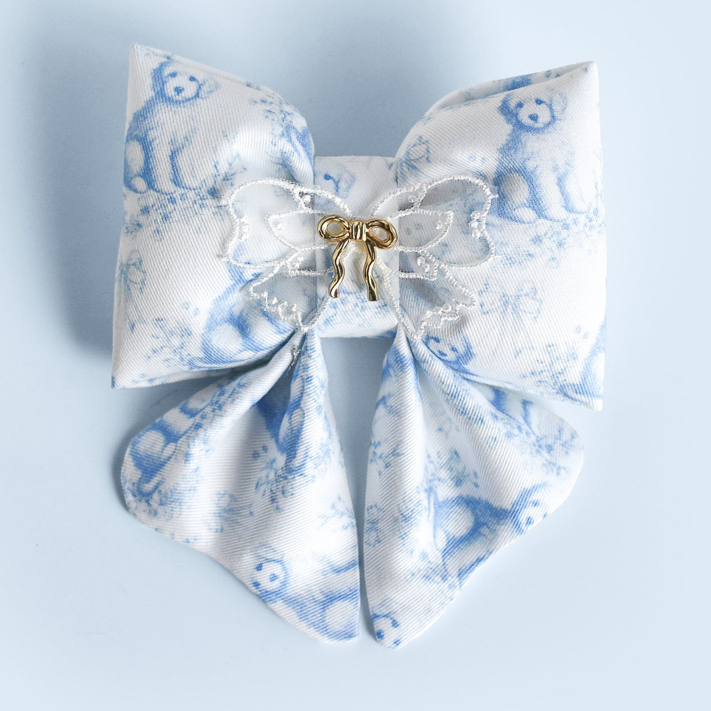 White bow with blue floral pattern on a light blue background