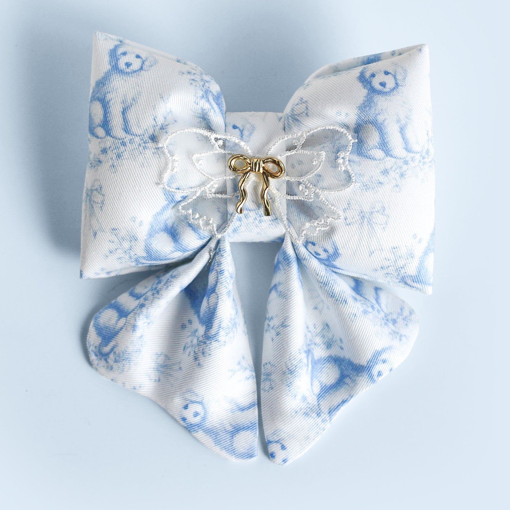 White bow with blue floral pattern on a light blue background