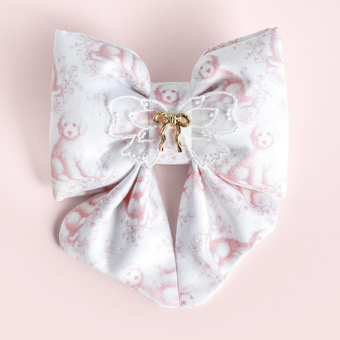 Large decorative bow with floral pattern on a pink background