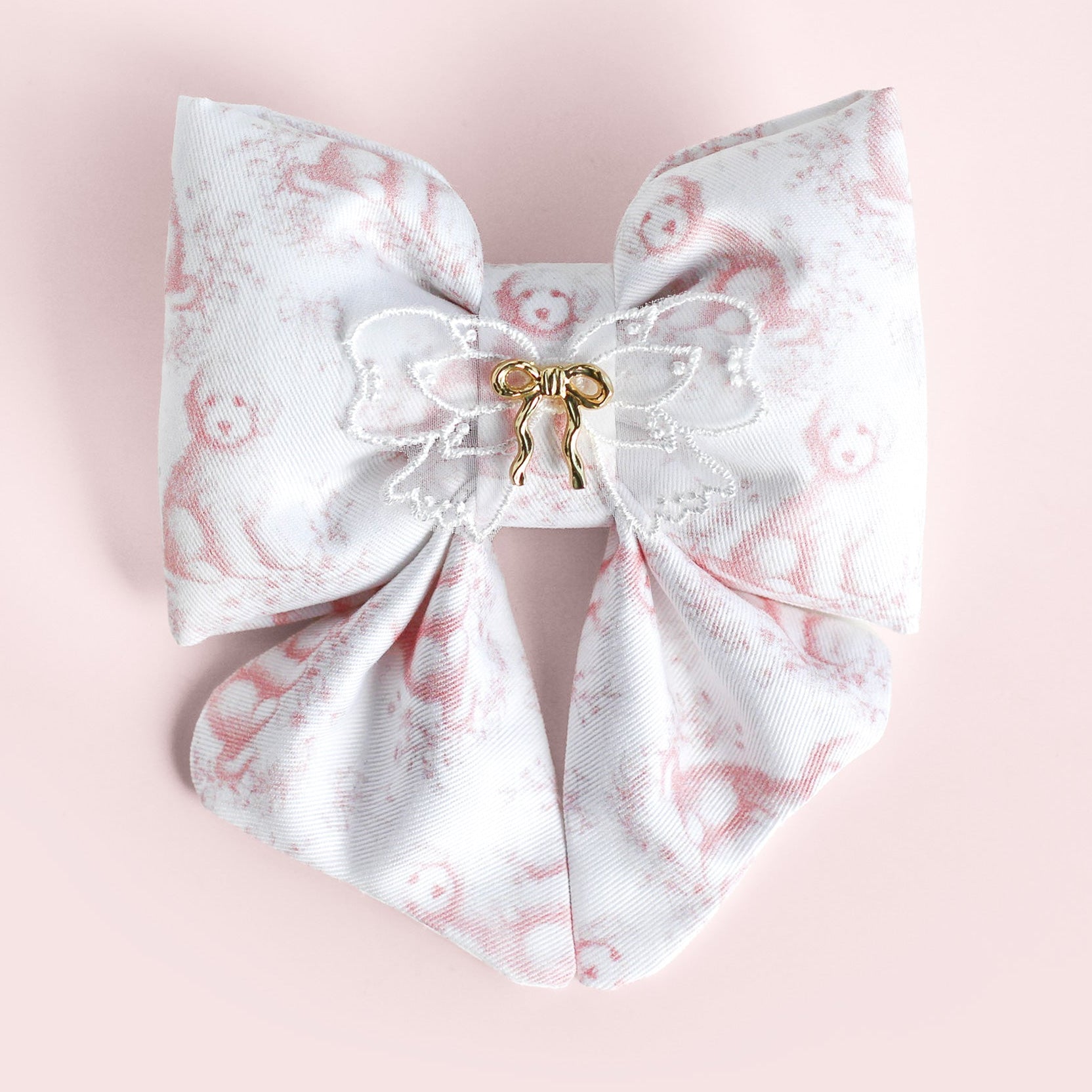 Large decorative bow with floral pattern on a pink background