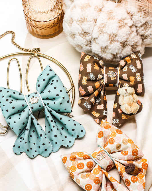 Colorful fabric bows on a white surface with decorative elements.
