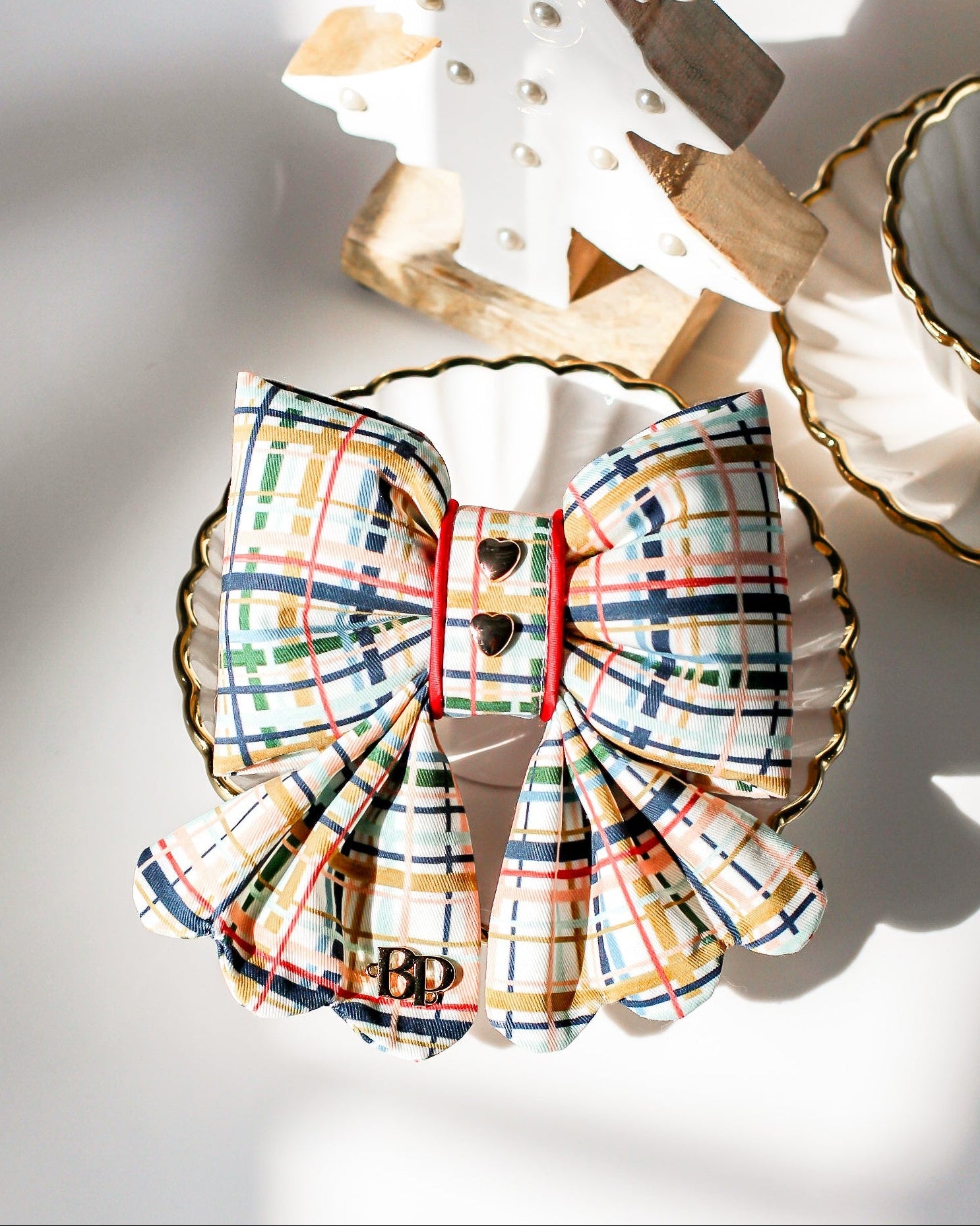Plaid bow with gold plated heart metal buttons with decorative items. Holiday dog bows for premium handmade dog goods. Bop Pop Pets scalloped bows. Red satin piping trim for festive style
