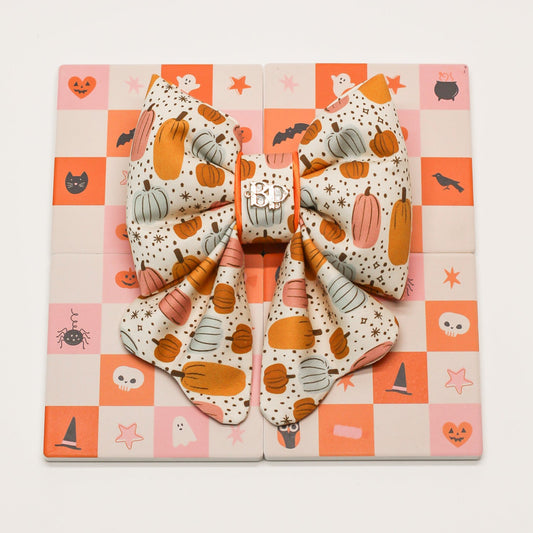 Pumpkin magic bow tie for pets dogs and cats.  Halloween-themed  or Fall autumn theme on a checkered background