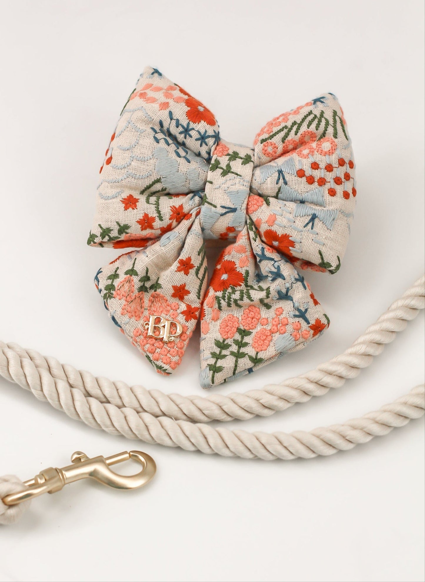 Celebration Sailor bow tie dog cats embroidery fabric and gold label tag. High quality luxurious premium handmade pet accessory. Dog gift Sailor bow bop pop pets Beige Buff Natural Linen with floral flowers in coral, peach, olive, teal and light blue. Wedding bows for dogs