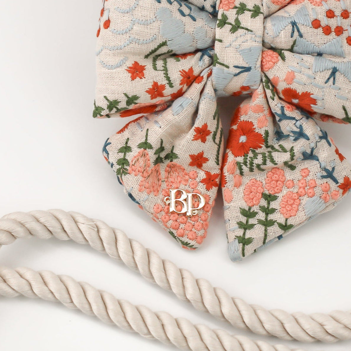 Celebration Sailor bow tie dog cats embroidery fabric and gold label tag. High quality luxurious premium handmade pet accessory. Dog gift Sailor bow bop pop pets Beige Buff Natural Linen with floral flowers in coral, peach, olive, teal and light blue. Wedding bows for dogs