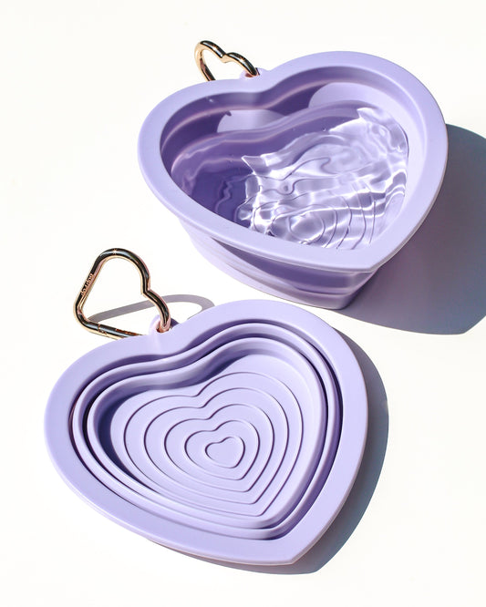 Collapsible portable purple pet water or food bowl. Silicone and lightweight for cafe or travel. Gold heart carabiner by Bop Pop Pets. Lavender purple color luxury style and elevated water bowl.