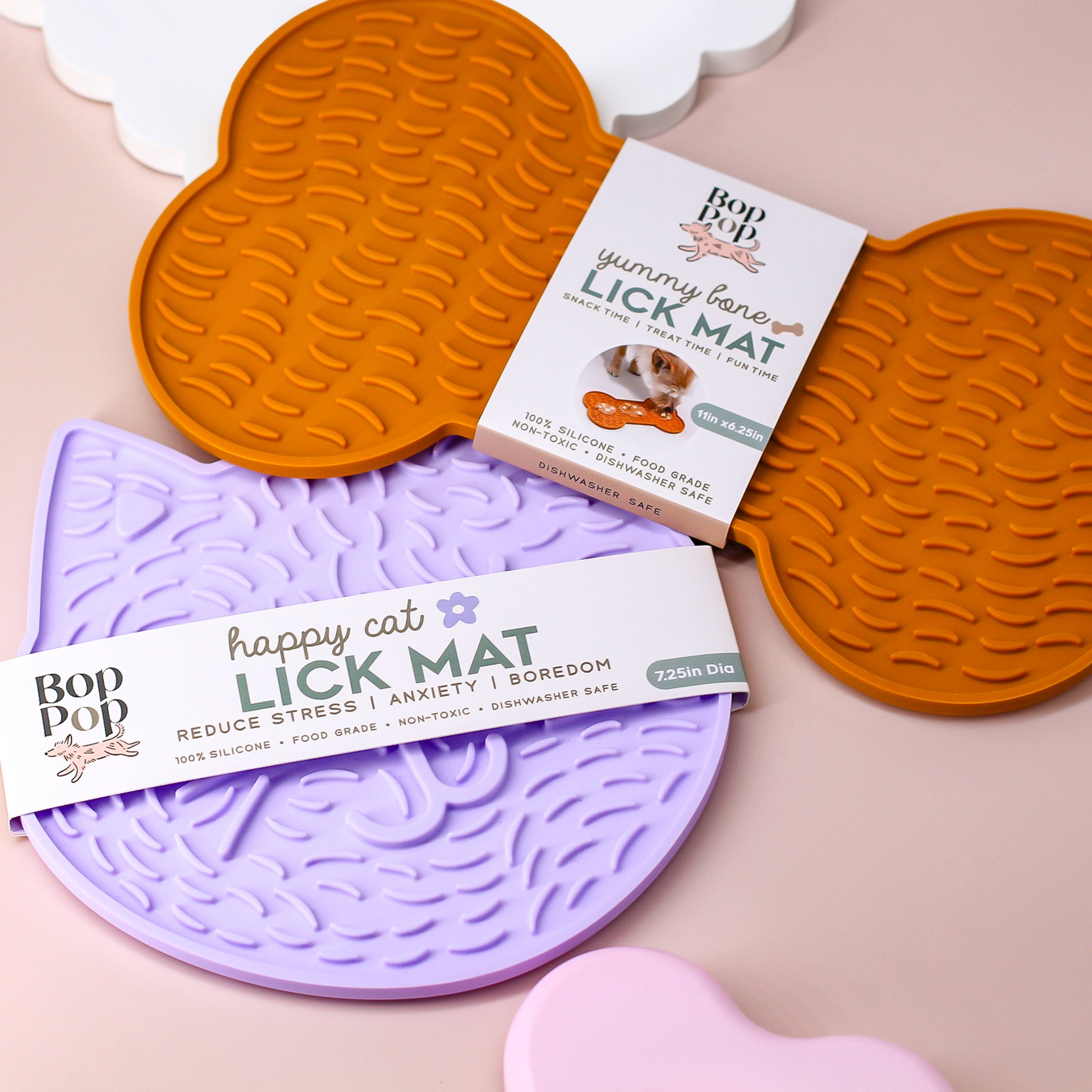Bone and Cat Lick Mat displayed for the Dogs and Cat Collection by Bop Pop Pets featuring the brand's paper wrap packaging detailing LICK MAT title and suggested usage for Snack time, treat time for Fun Time and size dimensions. Including benefits of product and pet enrichment.