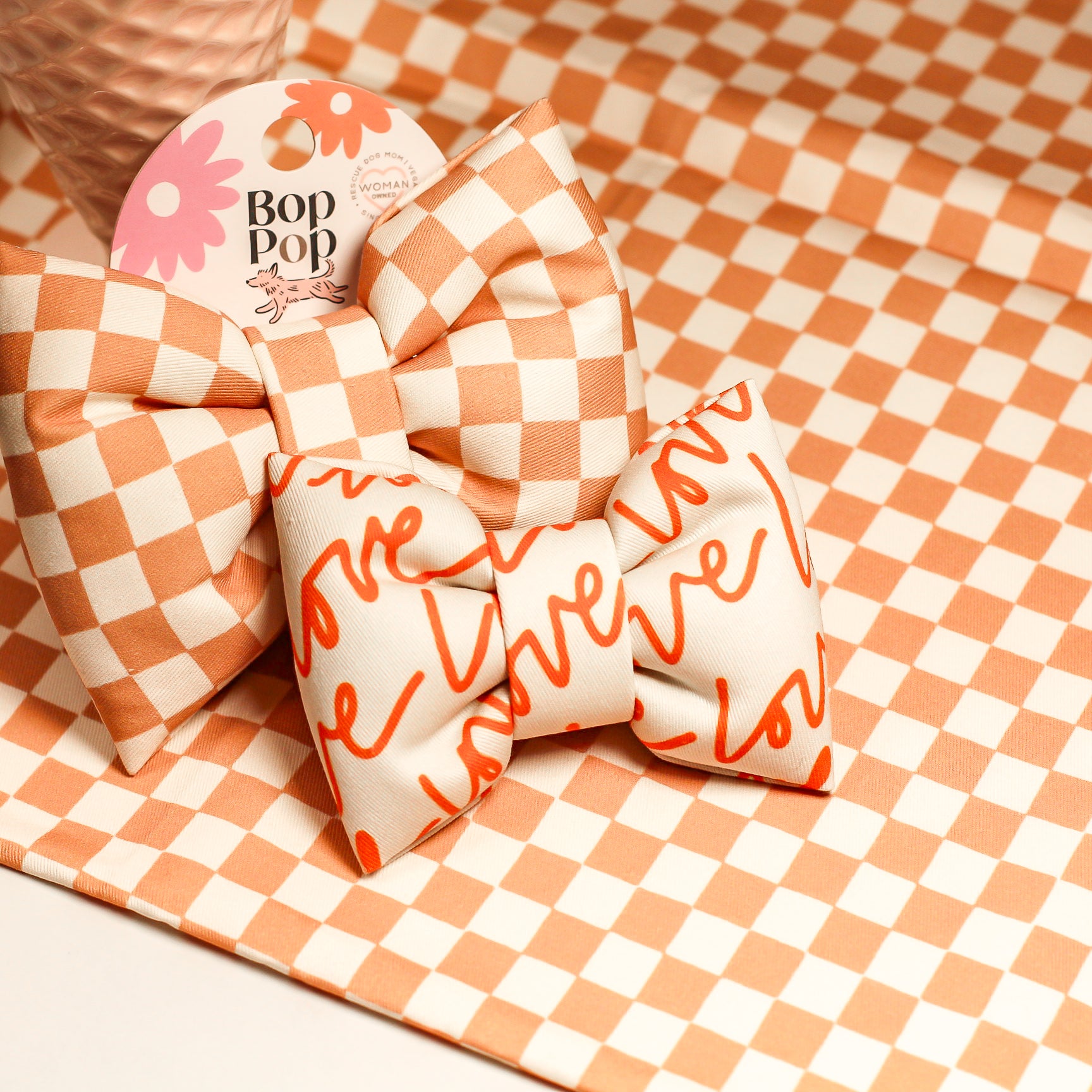 Two decorative pillows, one checkered and one with 'love' text, on a checkered background.
