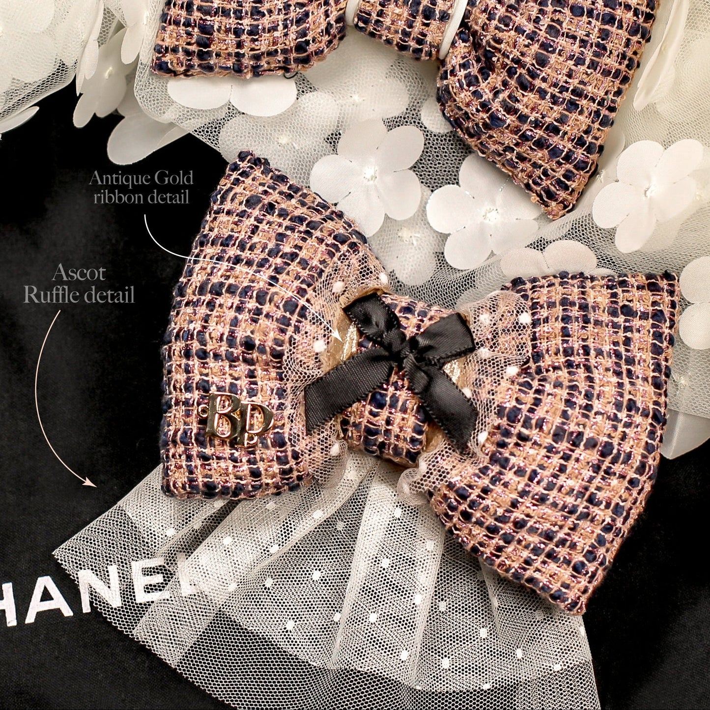 Chanel-inspired bow tie for pet accessories on a black background with white flowers.