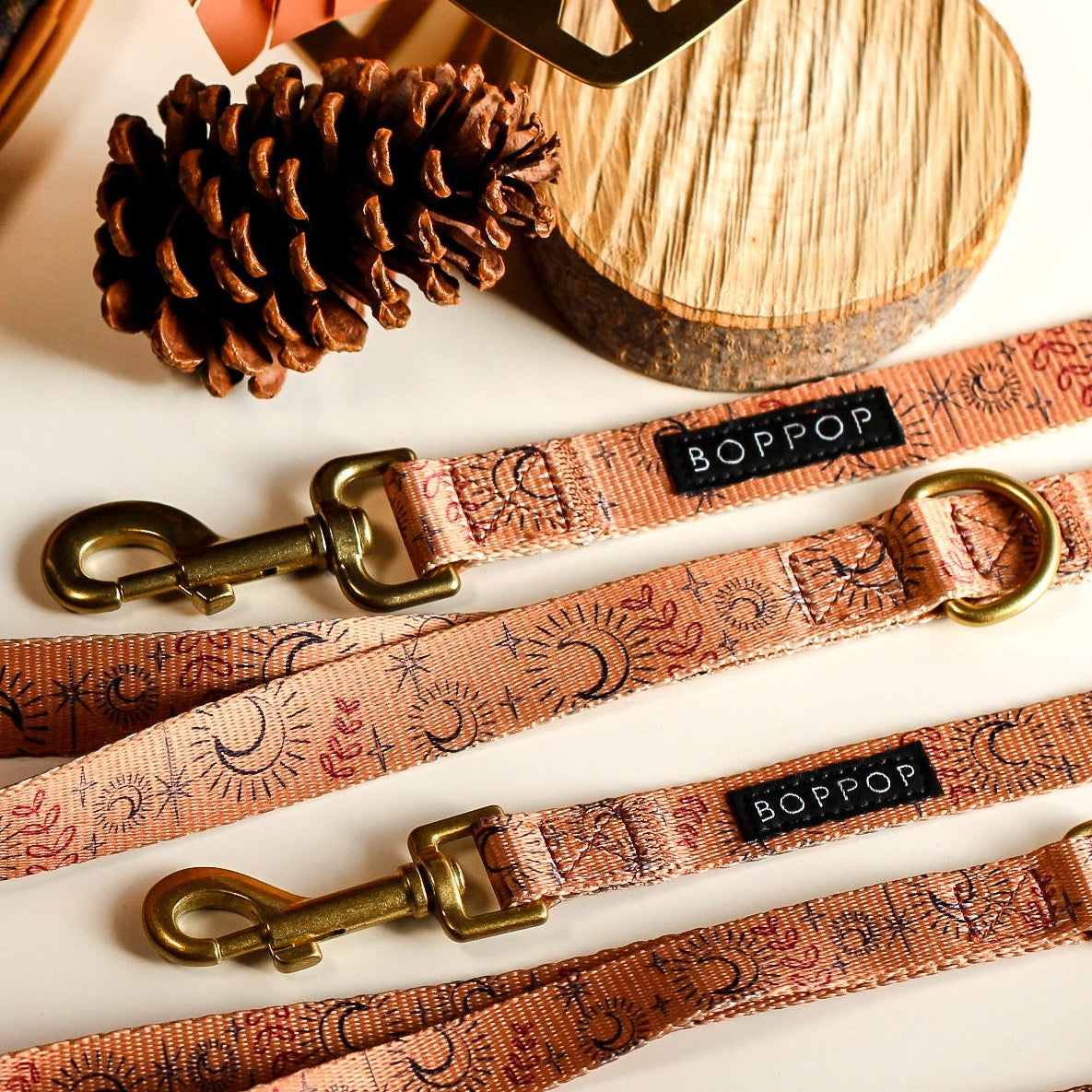 Dog leashes with gold clasps on a white surface, featuring the brand 'Boppy'.