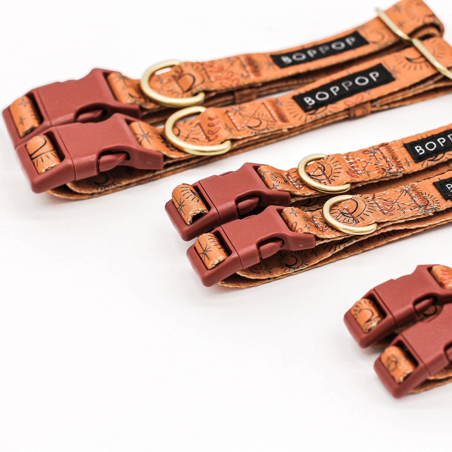 Brown dog collars with gold accents and 'BOPPOP' branding on a white background