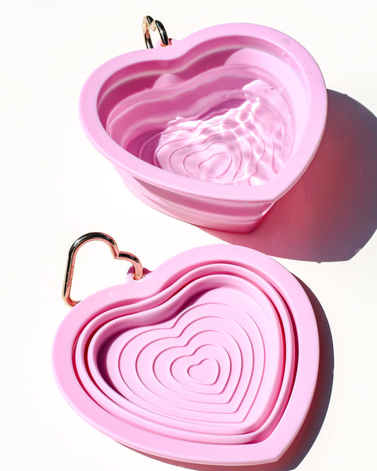 Collapsible portable pink pet water or food bowl. Silicone and lightweight for cafe or travel. Gold heart carabiner by Bop Pop Pets. Bright bubblegum pink color luxury style and elevated water bowl.