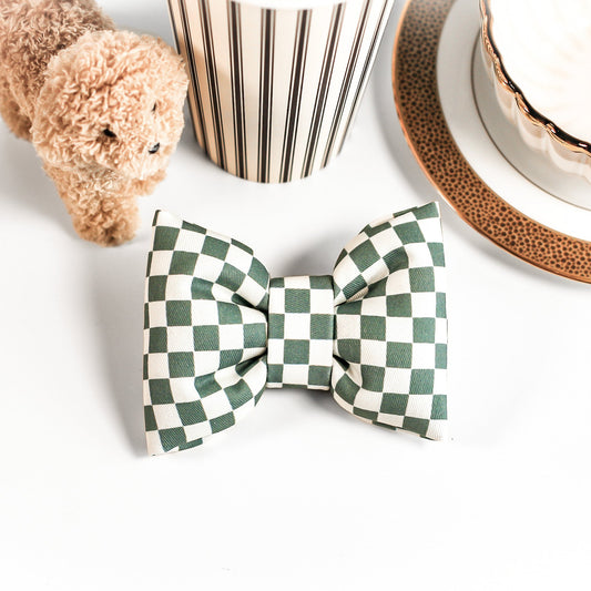 Green white Checkered cotton puffy bow tie on a white table with coffee cups, saucer, doodle dog decor with Ralph Lauren vibes and plate