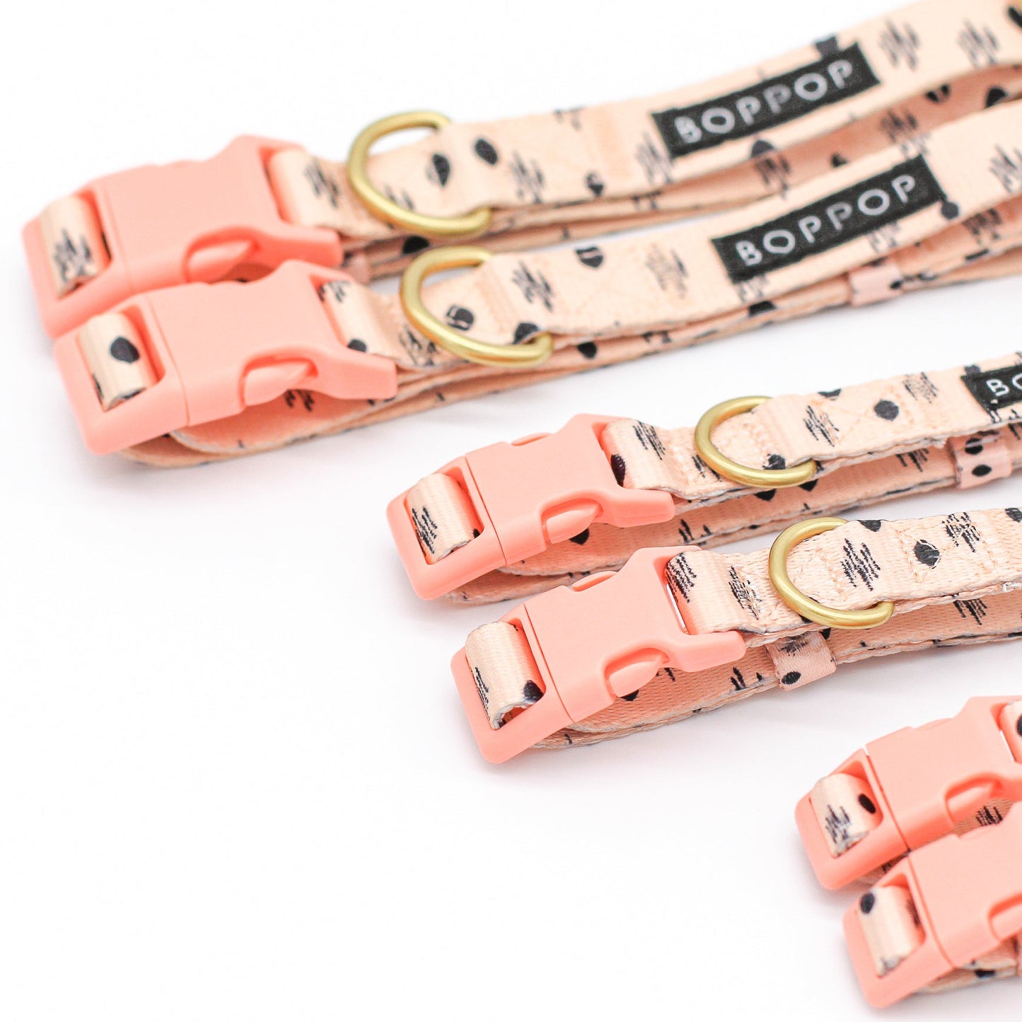 Set of pink dog collars with gold buckles and 'BOPPOP' branding on a white background