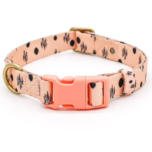 Dog collar with peachy pink floral pattern and coral buckle on a white background